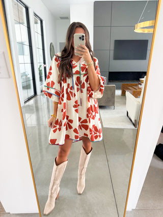 Rust floral boho dress with contrast trim styled with tall boots