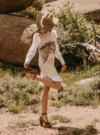 Equestrian chic sweater dress with faux white shirt underneath.