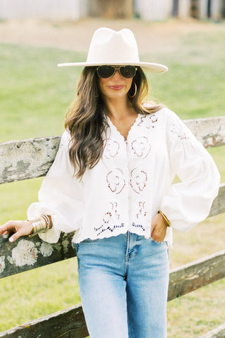 Woman wearing a white lightweight denim top.