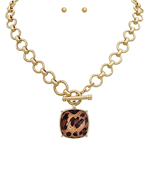 Gold necklace with a leopard print pendant on a white background